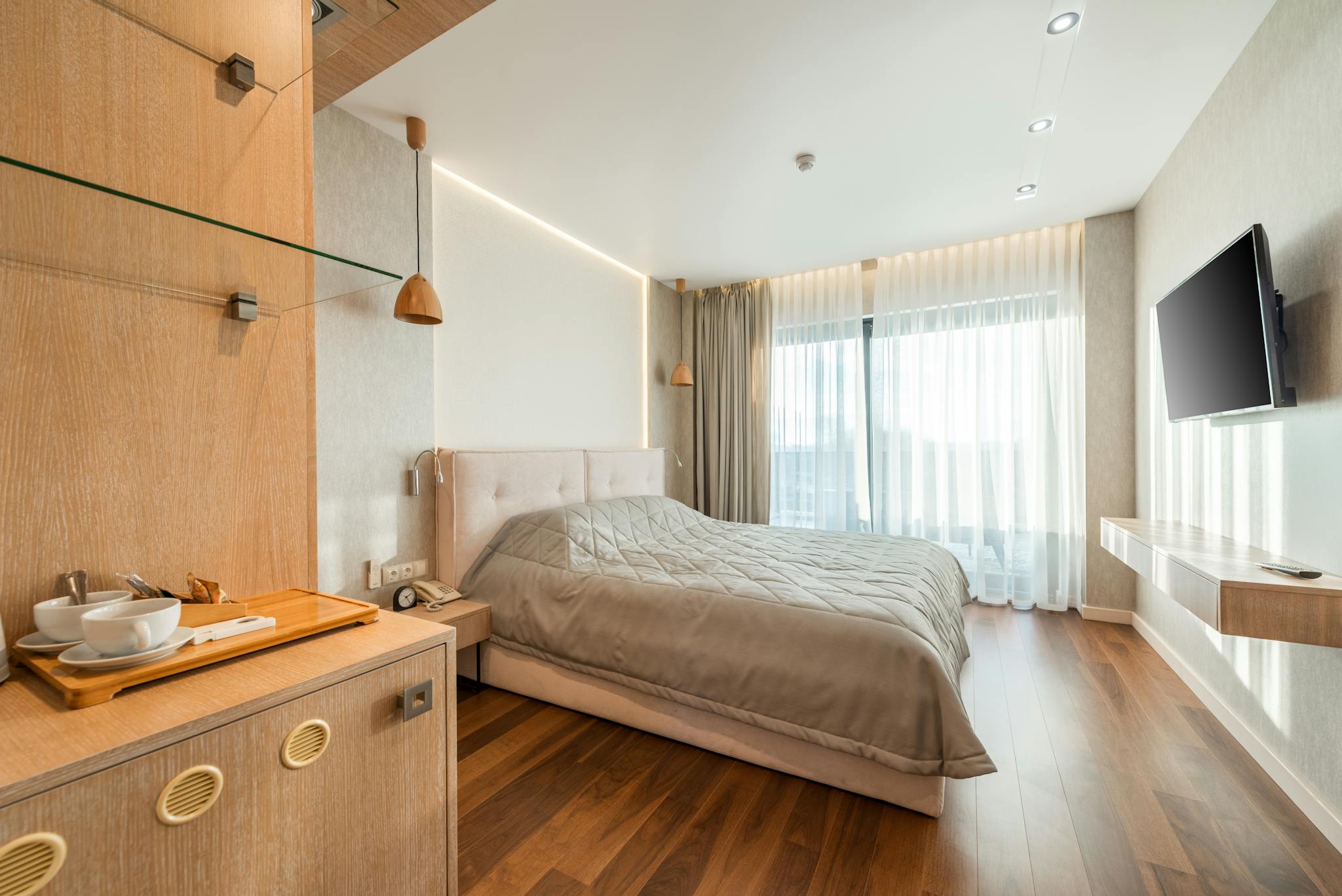 Spacious and elegant hotel room interior featuring modern design elements and abundant natural light.